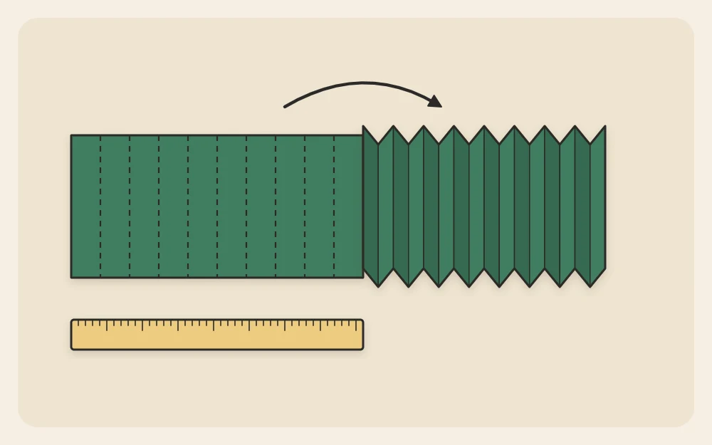 A paper strip with evenly spaced score lines, half of it folded into back-and-forth pleats
