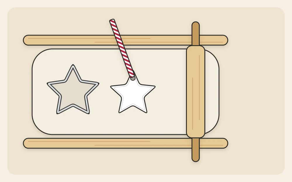 Clay rolled out between two flat guide sticks with a star cutter pressed into it and a straw making the hanging hole