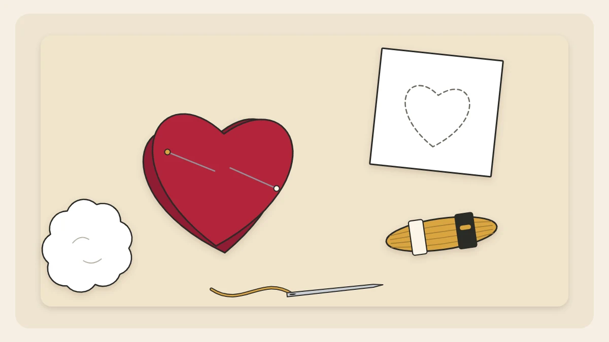 Two red felt hearts pinned together beside a paper template, embroidery floss, a needle and a tuft of stuffing