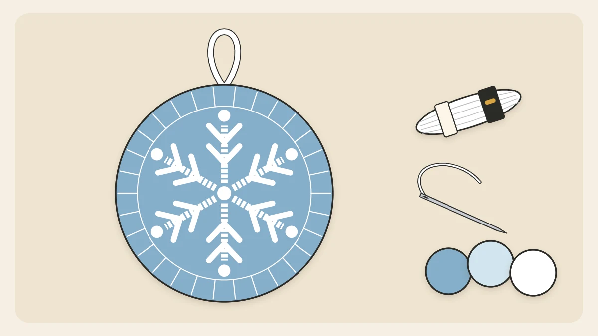 A round blue felt ornament with a white embroidered six-spoke snowflake design and a white ribbon loop