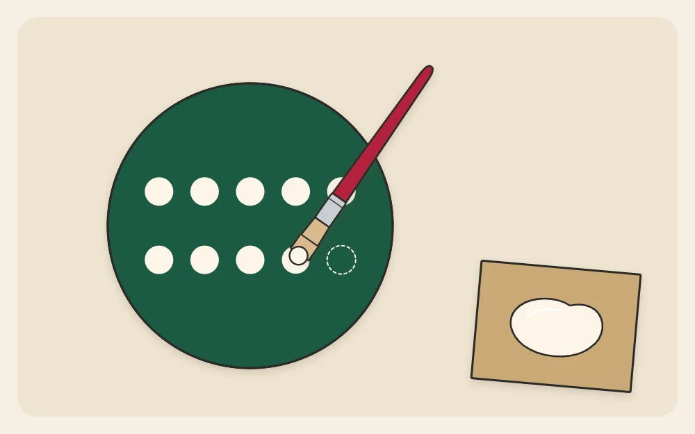 Dots being made with the end of a brush handle dipped in paint: a row of even dots on a disc and a small puddle of paint