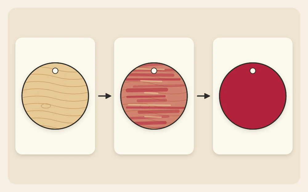 Three coats shown on three wooden discs: bare wood, a thin streaky first coat and a solid second coat