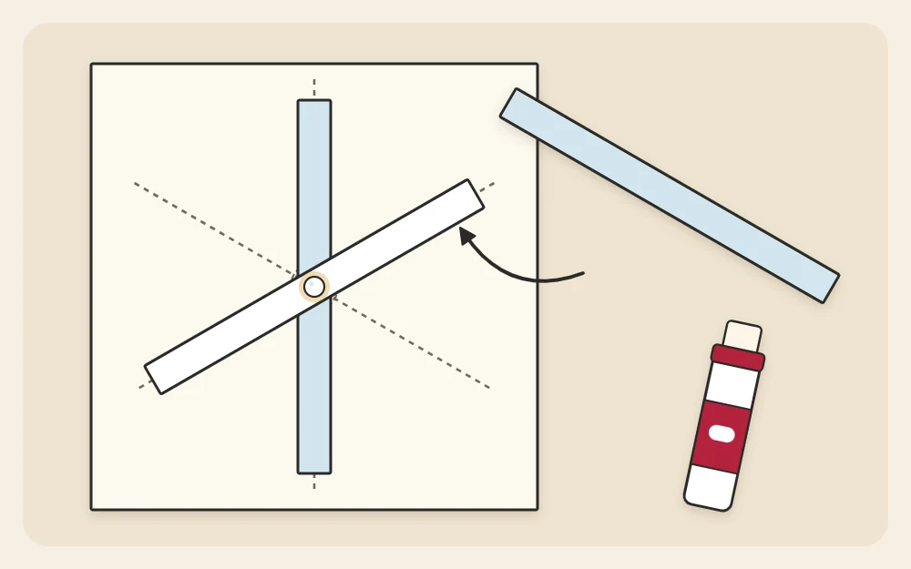 A drawn guide of three lines crossing at even angles with paper strips being glued along them