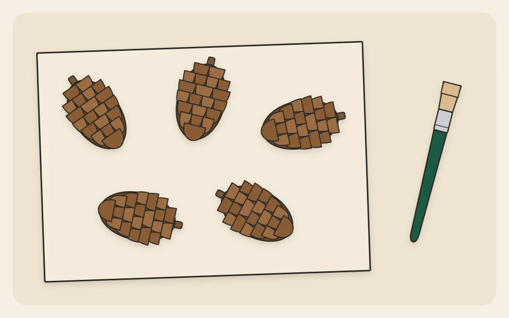 Pinecones spread out on a sheet of paper to air-dry with a small dry brush beside them