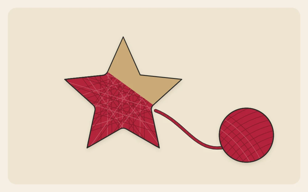 A cardboard star half wrapped in yarn with bare cardboard on two points and yarn leading to a ball